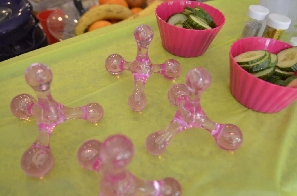 pink and green kids spa party setup cucumbers